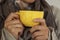 female hands holding a cup of coffee sweater