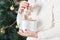 Female hands holding a cute happy bear