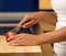 Female hands holding cutting apple in kitchen