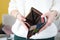 Female hands holding empty leather wallet closeup