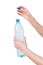 Female hands holding empty plastic bottle isolated on white. Recyclable waste. Recycling, reuse, garbage disposal