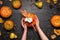 Female hands holding festive fall decor from pumpkins