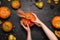 Female hands holding festive fall decor from pumpkins