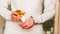 Female hands holding golden paper envelope with hearts. opening gold origami envelope