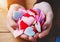 female hands holding heap of colorful textile hearts