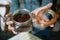 Female hands holding jar with ground coffee