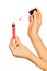 Female hands holding lip gloss tube and applicator