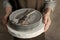 Female hands holding pile of dishware