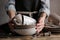 Female hands holding pile of dishware