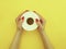 Female hands holding a roll of clean sanitary toilet paper on a colored background