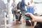 Female hands holding and using smartphone while charging it in a public place using electric plug and a charging cable