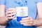 Female hands holding white blue cup with inscription. Coffee is always a good idea. Break time concept