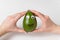 Female hands holds avocado with funny face. Avocado with Googly eyes and smile