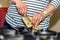 Female hands impatiently open well packed christmas gift with knife