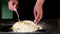 Female hands knead eggs in flour for making dough