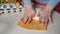 Female hands kneading dough in flour on the table, adds egg to flour, adds ingredients baking powder, sugar kneads the