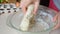 Female hands kneading dough in flour on the table, adds egg to flour, adds ingredients baking powder, sugar kneads the