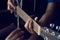 Female hands learning to play on acoustic guitar