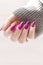 Female hands with long nails with light pink nail polish