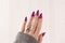 Female hands with long nails with light pink nail polish