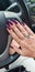 Female hands with long nails with purple nail polish