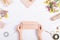 Female hands make holiday decorations on a white table