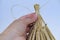 female hands make ritual doll made of straw, grass in honor rich harvest, scarecrow for fertility, old toy, amulet for children,