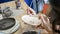 A female hands making a ceramic plate, painting and drawing on ceramic plate