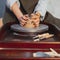 Female Hands Making Clay Tableware on Workshop. Pottery Wheel Near Ceramist Tools