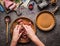 Female hands making minced meat stuffing on kitchen table background with meat, force meat , meat grinder and spoon, top view. Co