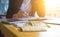 Female hands making notes at copybook. Businesswoman sitting at table in cafe, working on laptop