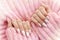 Female hands manicure close up view on pink knitted sweater background. Nail painting effects. Manicure salon banner