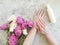 Female hands manicure cream moisturizer hygiene cosmetic purity flower peony on concrete background