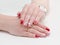 Female hands with manicure, red nail polish, drawing with cherries. White background.