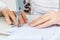 Female hands of a master tailor at work, a sewing machine needle