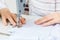 Female hands of a master tailor at work, a sewing machine needle