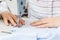 Female hands of a master tailor at work, a sewing machine needle