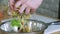 Female hands mixing vegetable salad in bowl. Slowly