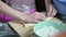 Female hands mold pastries from the dough, at this time children's hands appear