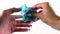 Female hands are molded from light airy multicolored blue plasticine, developing activities for children.