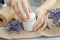 Female hands open a jar of lavender moisturizer