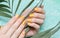 Female hands with orange nail design