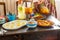 Female hands over a table covered with healthy food terrace in the morning in Villa in tropical country