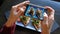 Female hands photographing appetizing food by smartphone in the restaurant.