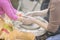 Female hands of potter and girl s hands . Master teaches student to make pitcher on pottery wheel. Master class of clay