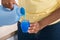 Female Hands Pouring Detergent In The Blue Bottle Cap