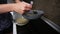 Female hands pouring pancake mix in a frying pan. Homemade food. Slowmotion shot