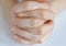 Female hands praying in faith folded in prayer position on white background, a close-up