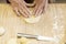 Female hands preparing dough pies to bake