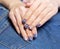 Female hands with professional blue and silver manicure